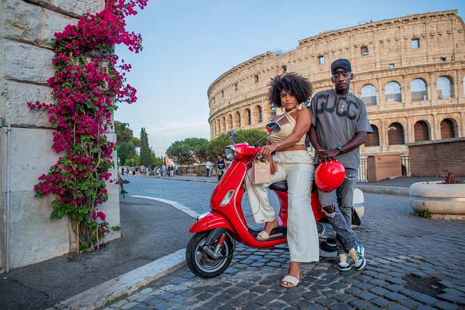 A red Vespa parked in the shade of the Colosseum in Rome